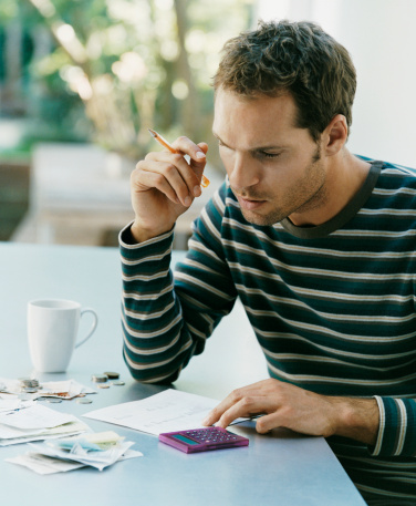 Serious Looking Man Examining a Bill