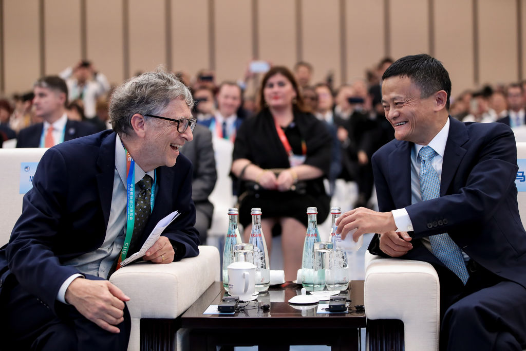 SHANGHAI, CHINA - NOVEMBER 05: Microsoft founder Bill Gates (L) talks with Alibaba Chairman Jack Ma (R) bfore duirng the Hongqiao International Economic and Trade Forum in the China International Import Expo at the National Exhibition and Convention Centre on November 5, 2018 in Shanghai, China. The first China International Import Expo will be held on November 5-10 in Shanghai. (Photo by Lintao Zhang/Getty Images)