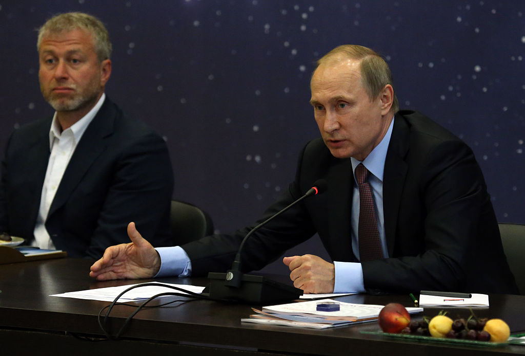 SOCHI, RUSSIA - JULY 19: (RUSSIA OUT) Russian President Vladimir Putin (R) speaks as billionaire and businessman Roman Abramovich (L) looks on during a meeting with top businessmen while visiting the Sirius education center for gifted children on July 19, 2016 in Sochi, Russia. Vladimir Putin said the latest report on doping among Russian athletes lacked substance and was highly political. The Russian president said officials named in the report will be temporarily suspended. (Photo by Mikhail Svetlov/Getty Images)